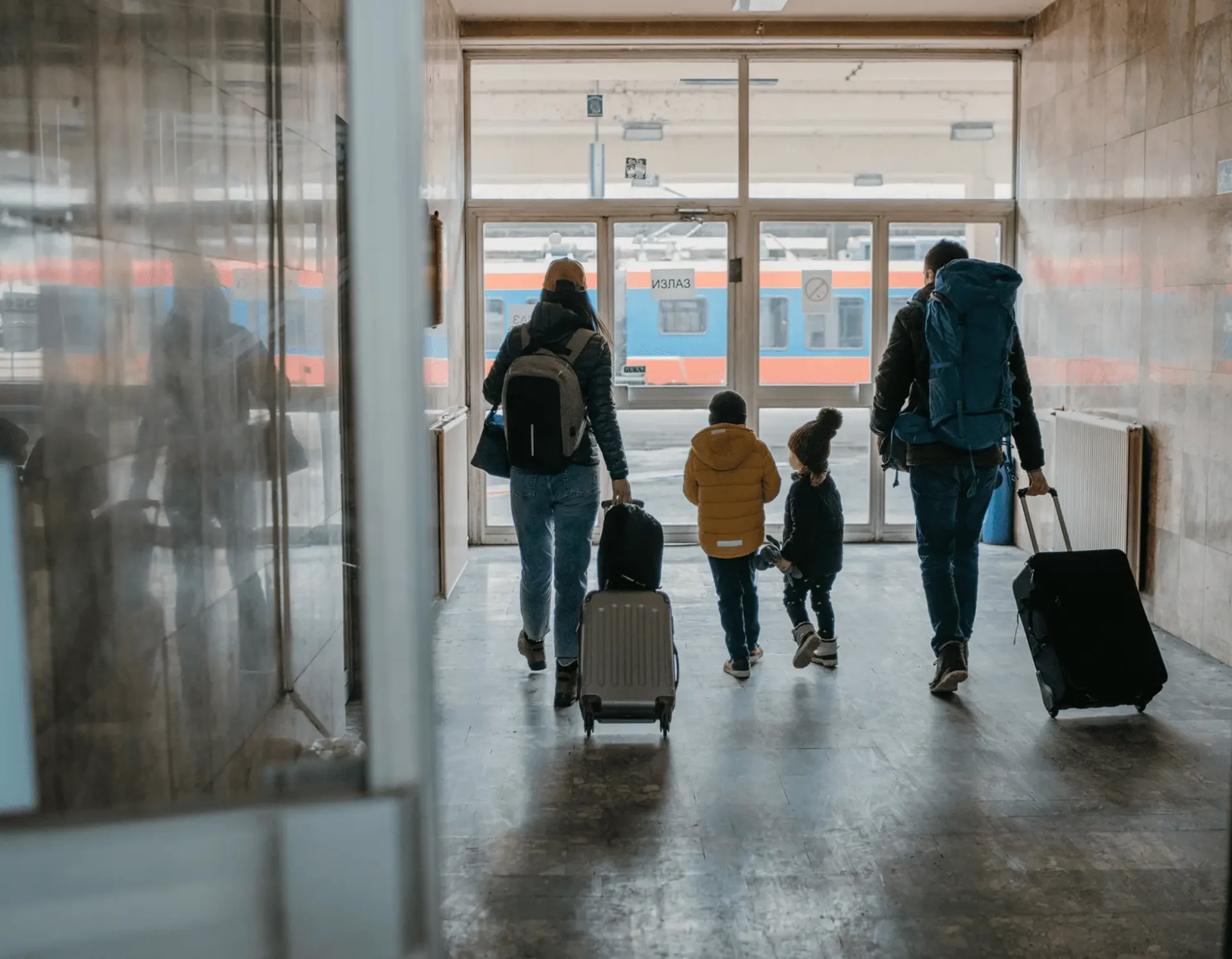 Travelers walking through an airport terminal with luggage